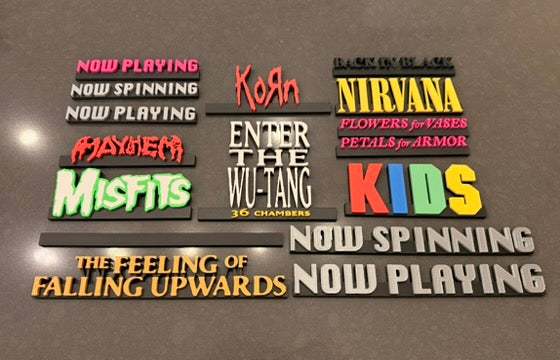 Collection of music album title SpinTags on a reflective surface